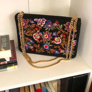 Black purse with colorful flower embroidery and gold chain Aldo
